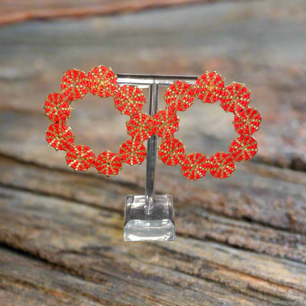 A pair of hand knitted red and golden circle earrings