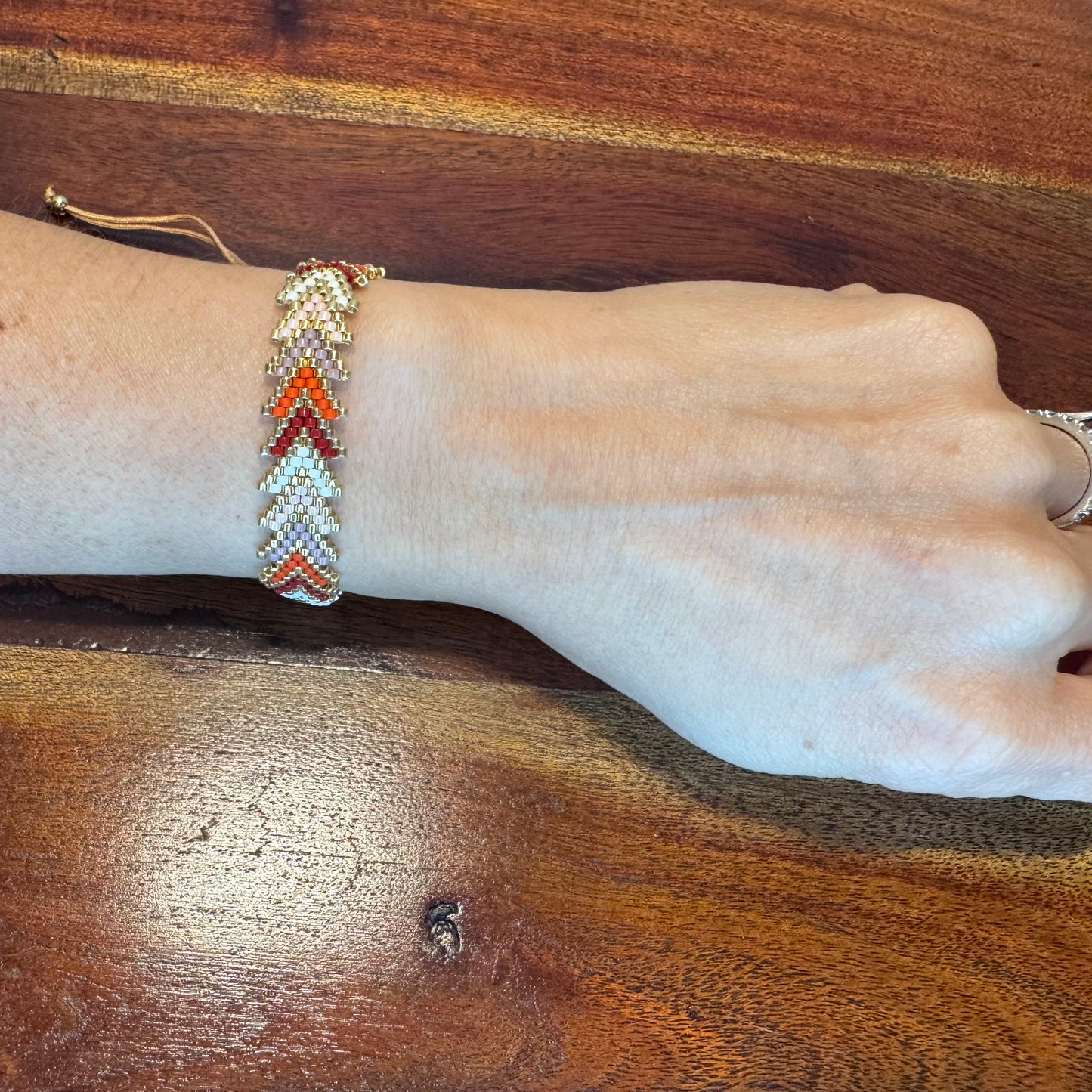 Hand wearing a beaded bracelet
