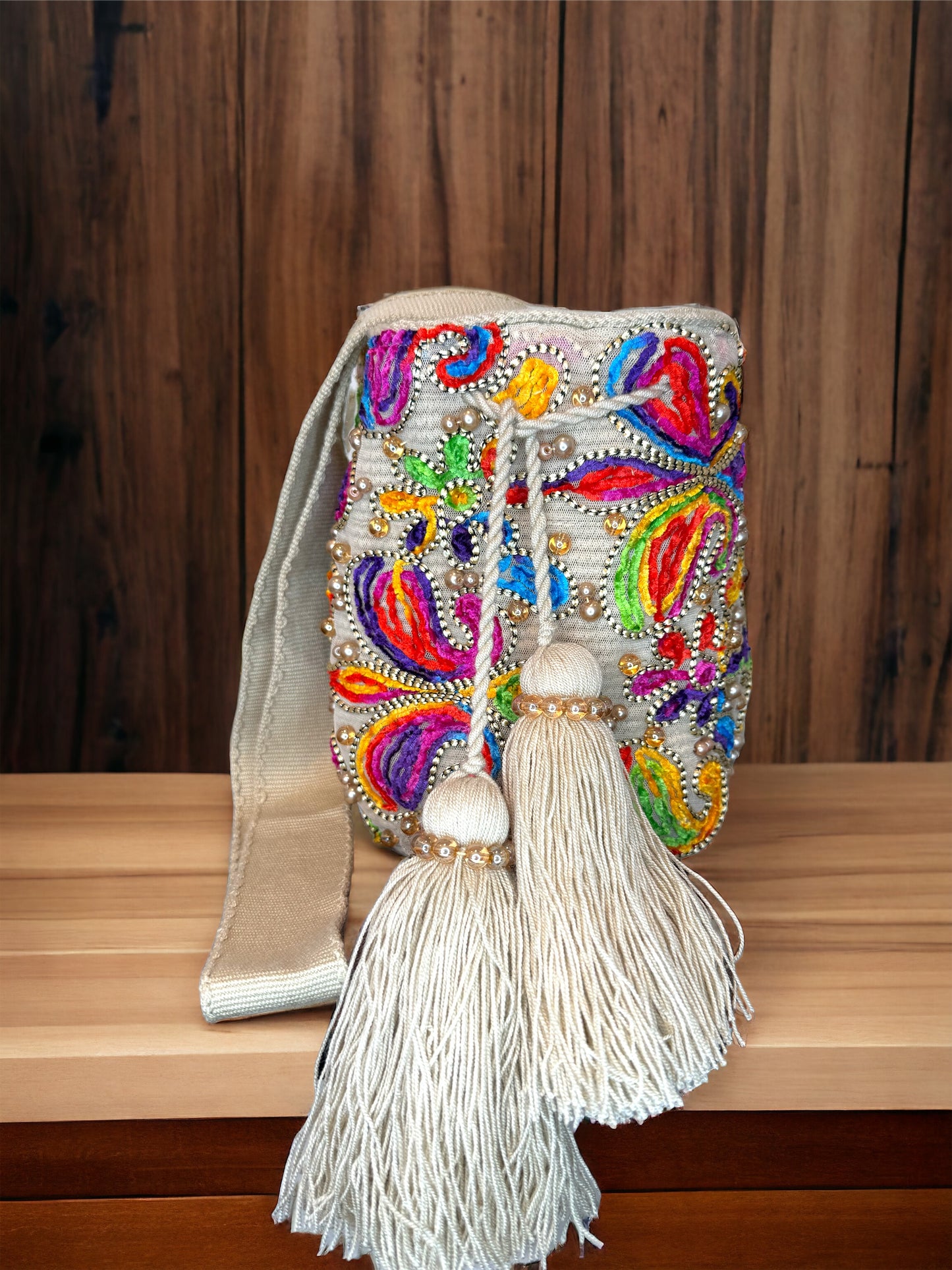 A multicolored, beaded mochila shoulder bag with a tassel, hand woven bag