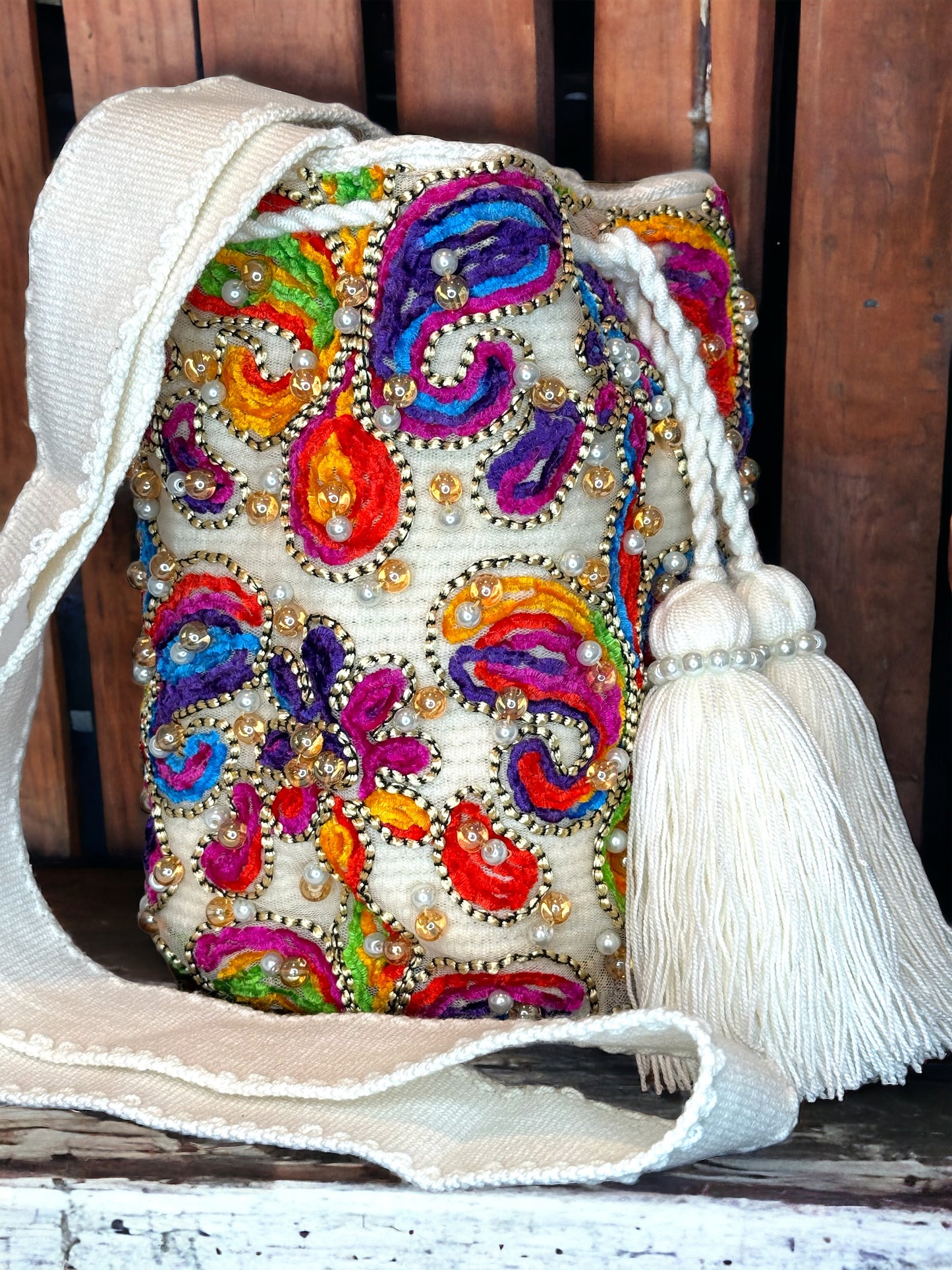 A multicolored, beaded mochila shoulder bag with a tassel, hand woven bag