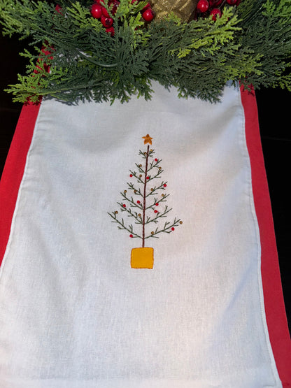 A set of white linen napkins with Christmas themed hand embroidery