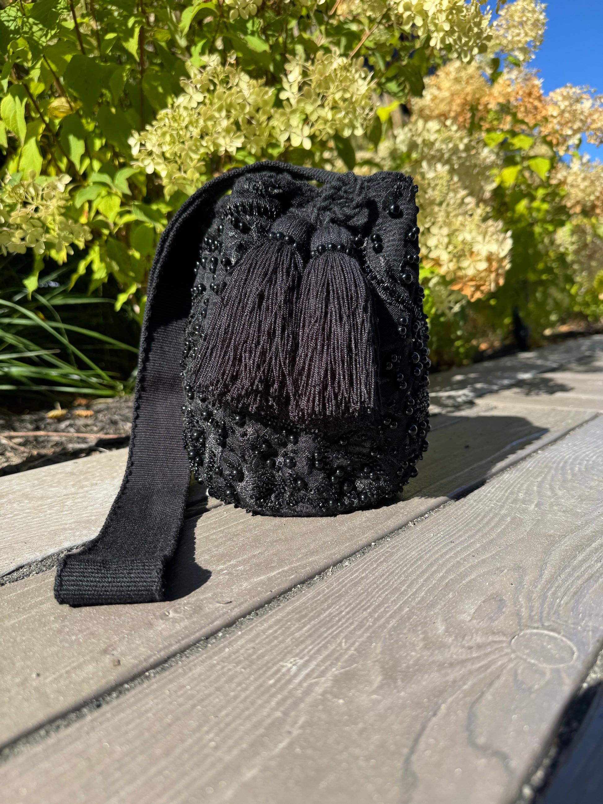 Black hand woven bag with tassel with beads and pearls 