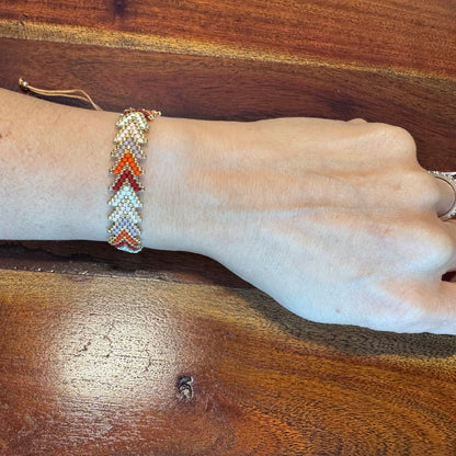 Hand wearing a beaded bracelet 