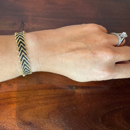 hand woven miyuki bracelet, black and gold colours, adjustable strap
