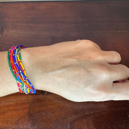 Hand wearing a colorful beaded bracelet