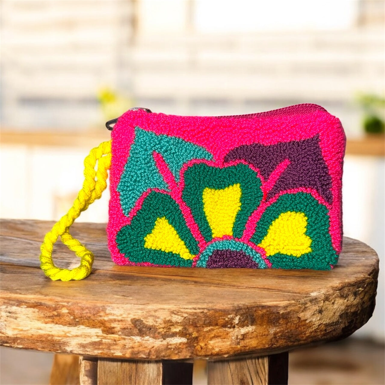 Colorful handbag with floral design on a wooden surface