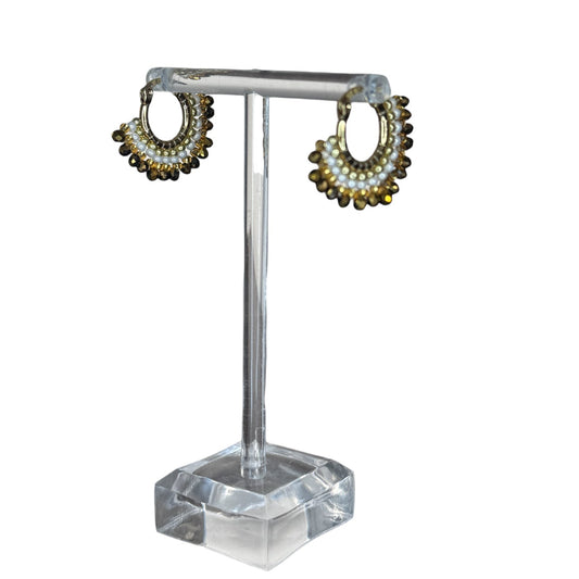 Pair of hoop earrings on a clear stand with a white background