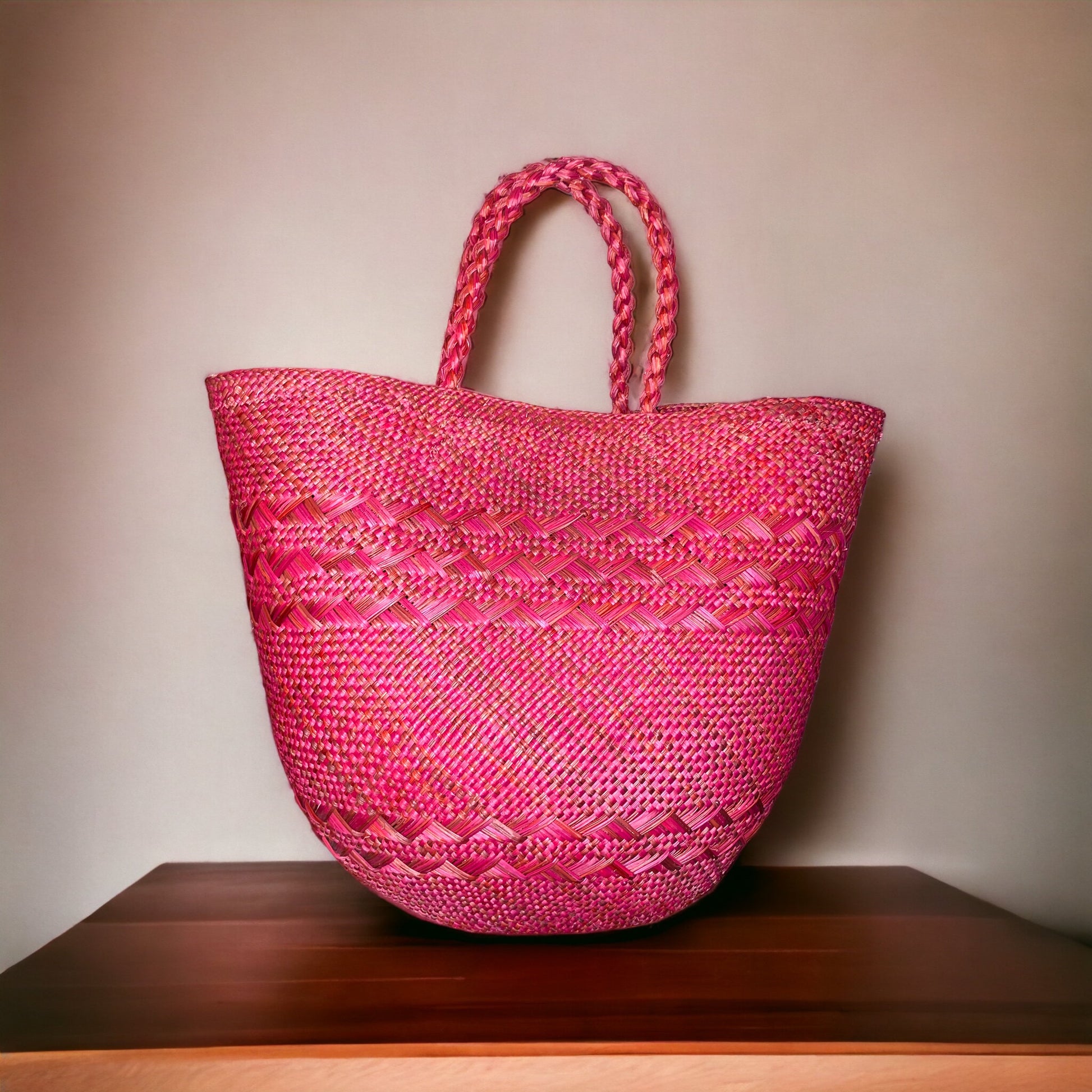 bergamot woven handbag on a wooden surface with a beige background