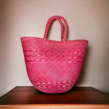 bergamot woven handbag on a wooden surface with a beige background