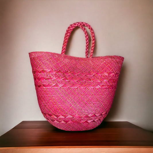 bergamot woven handbag on a wooden surface with a beige background