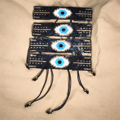 bracelets with eye designs on a beige surface