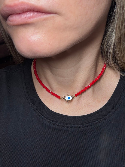 red beaded necklace with an eye pendant.