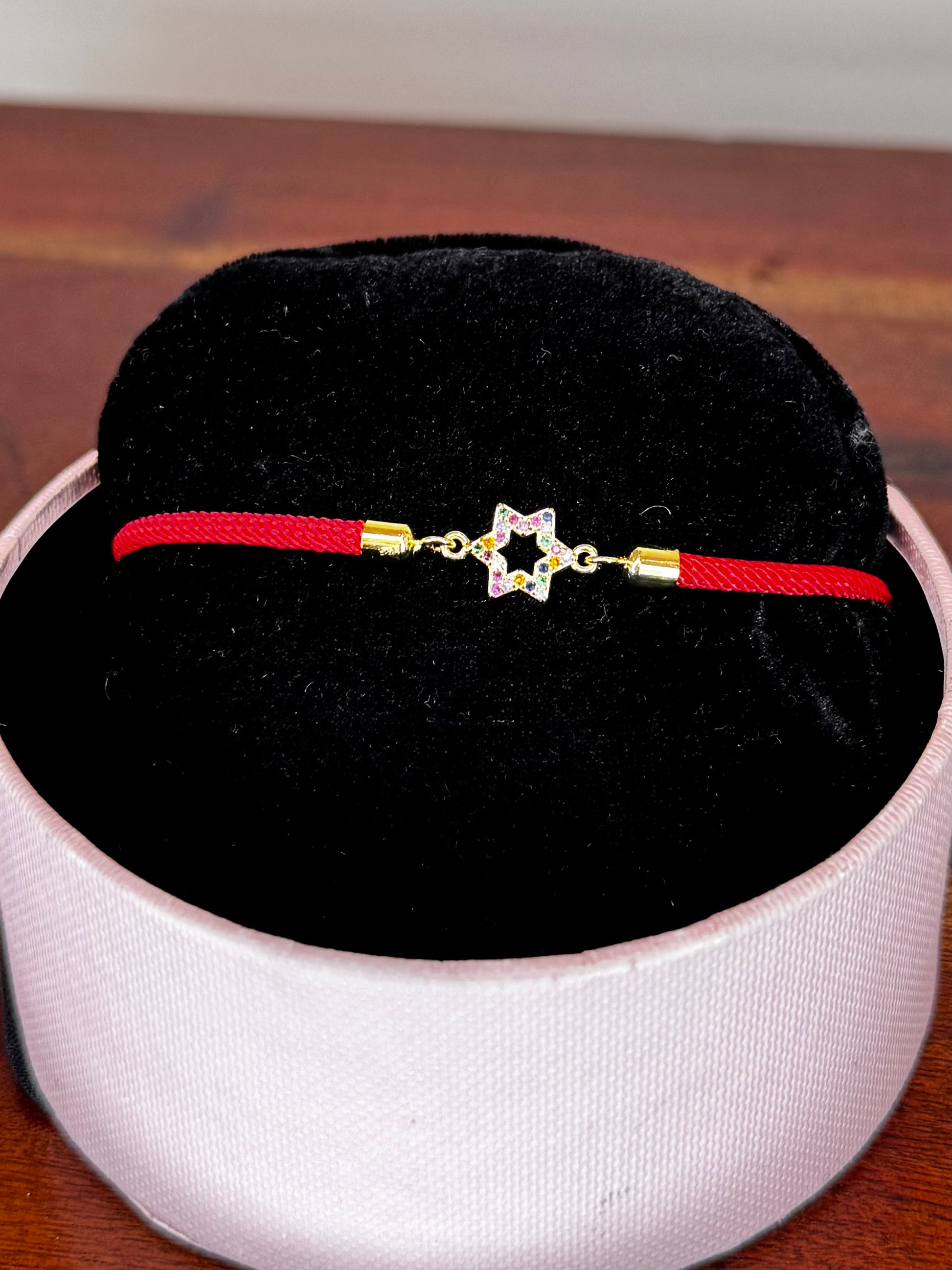 Red bracelet with a gold clasp 