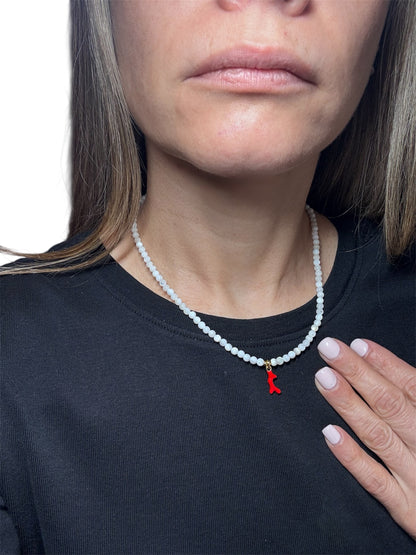 natural white gemstone necklace with a red coral pendant in the middle